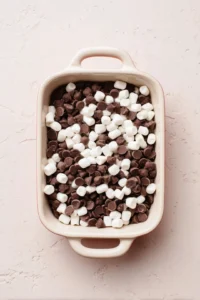 Combine chocolate chips and marshmallows in a small oven-safe dish
