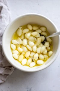 Combine garlic, olive oil, and salt in a bowl