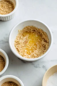 Combine graham cracker crumbs and melted butter in a mixing bowl