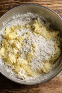 Combine grated malanga, water, gluten-free flour, salt, pepper, and garlic in a large bowl