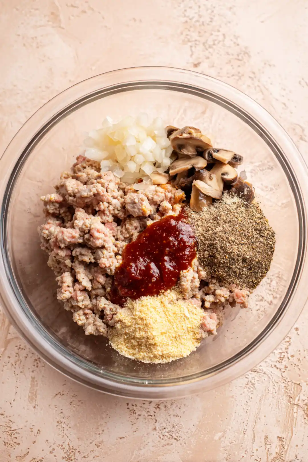 Combine ground turkey, chopped mushrooms, grated onion, Worcestershire sauce, garlic powder, salt, pepper, and optional bread crumbs in a large mixing bowl