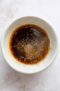 Combine ingredients to make marinade for venison steaks