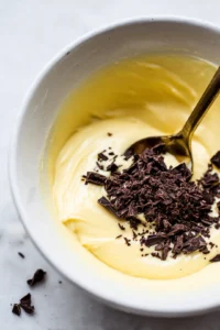 Combine melted butter and chopped chocolate in a bowl and mix until smooth