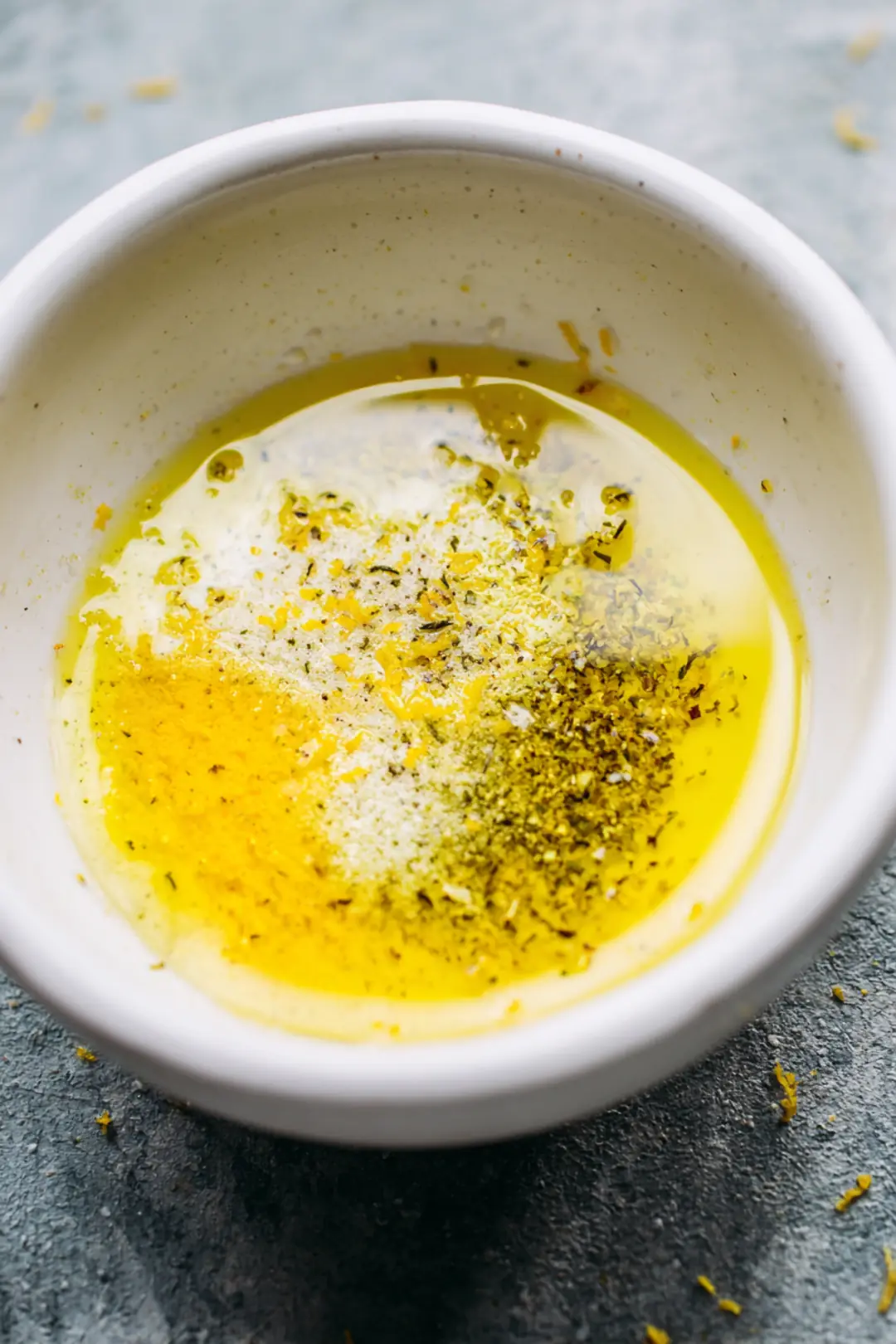 Combine melted butter, lemon juice, lemon zest, garlic powder, salt, and black pepper in a small bowl