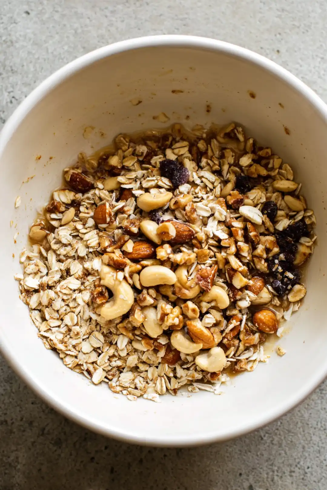 Combine oats, nuts, honey, coconut oil, cinnamon, and vanilla in a mixing bowl