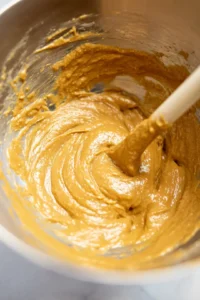 Combine peanut butter, sugar, and egg in a mixing bowl