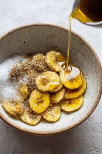 Combine plantain slices with olive oil, brown sugar, and salt