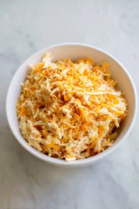 Combine shredded chicken, cheddar cheese, mozzarella cheese, and taco seasoning in a bowl
