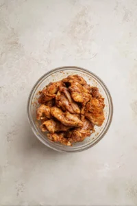 Combine sliced chicken breast with shawarma spices and lemon juice