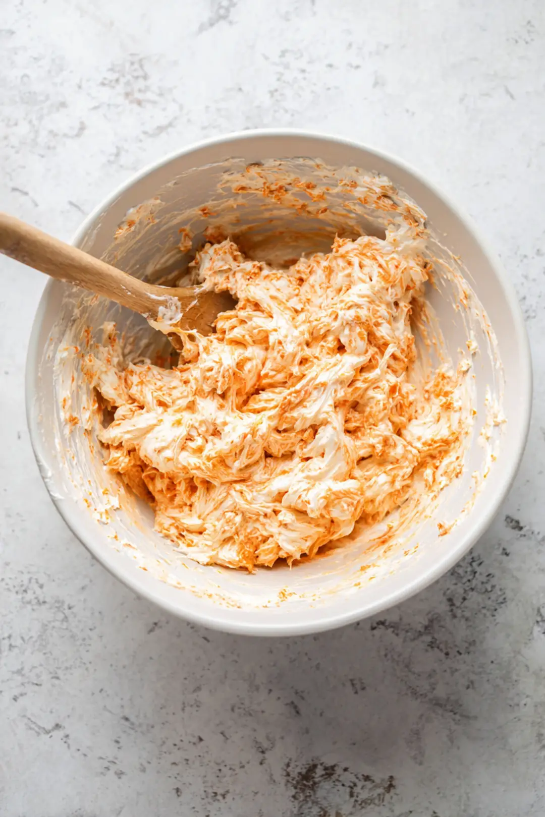 Combine softened cream cheese, shredded chicken, and buffalo sauce in a large mixing bowl