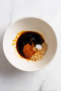 Combine soy sauce, garlic powder, and smoked paprika to create the marinade and coat the oyster mushrooms