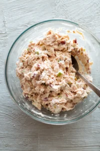 Combine the drained tuna with mayonnaise and mix thoroughly