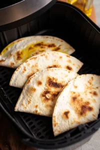 Cook quesadillas in air fryer until crispy and golden brown