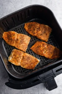 Cook the seasoned fish in the air fryer
