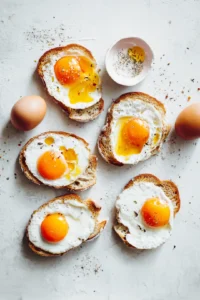 Crack an egg into each hole, season with salt and pepper, and add any optional add-ins if desired. Cook for 10 minutes or until the egg is cooked to your liking.