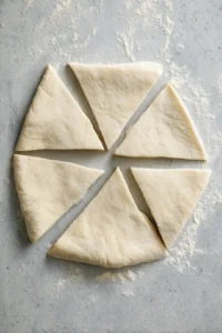 Cut crescent roll dough into smaller triangles