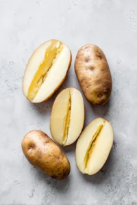 Cut potatoes in half and scoop out insides