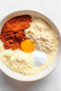 Dip each chicken strip in beaten egg and coat with breadcrumb mixture