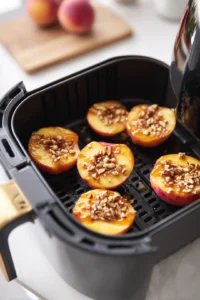 Drizzle honey over peach halves and sprinkle with chopped nuts