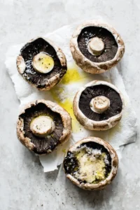 Drizzle portobello mushrooms with olive oil and season with salt and pepper