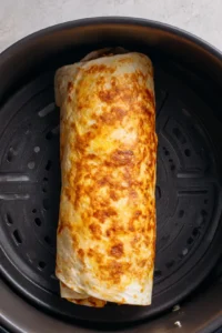 Fill a low carb tortilla with chicken mixture and roll it up tightly