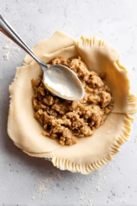 Fill each dough circle with a spoonful of filling and crimp the edges, then cook empanadas in air fryer