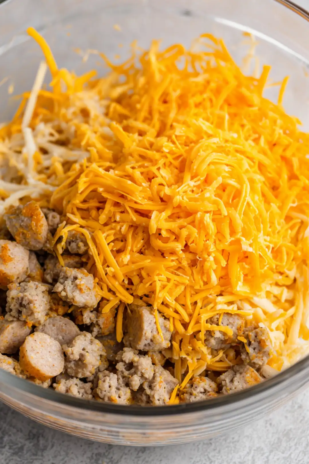 Fill each flour tortilla with the sausage and cheese mixture and roll tightly to create burritos