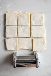 Fill puff pastry squares with strawberry mixture and fold them into triangles