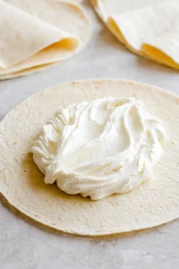 Fill tortillas with cheesecake filling and roll them up