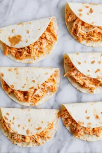 Fill tortillas with filling and fold in half