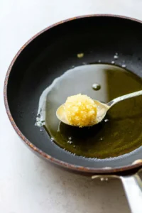 Heat oil in a pan over medium heat and drop in mixture