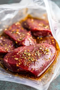 Marinate venison steaks in resealable bag