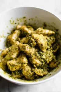 Mix chicken with pesto sauce until coated