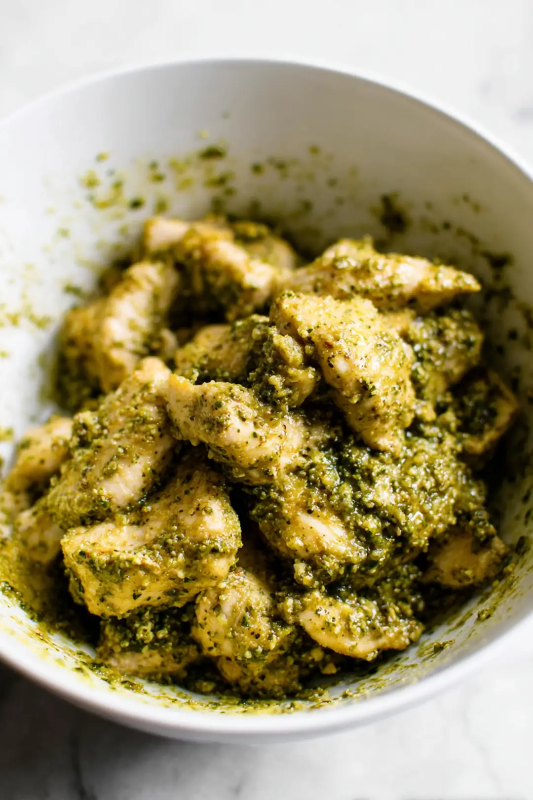Mix chicken with pesto sauce until coated