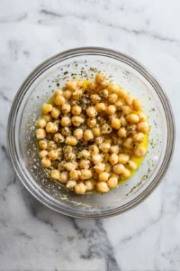Mix chickpeas with olive oil and seasonings