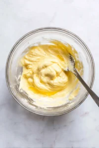 Mix egg yolks, mayonnaise, mustard, salt, and pepper until creamy