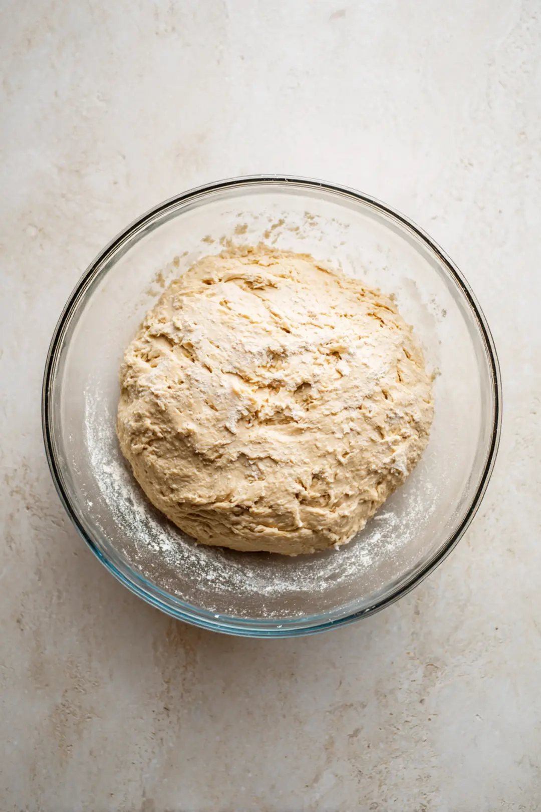 Mix flour, yeast, and salt in a large bowl and add warm water to form dough