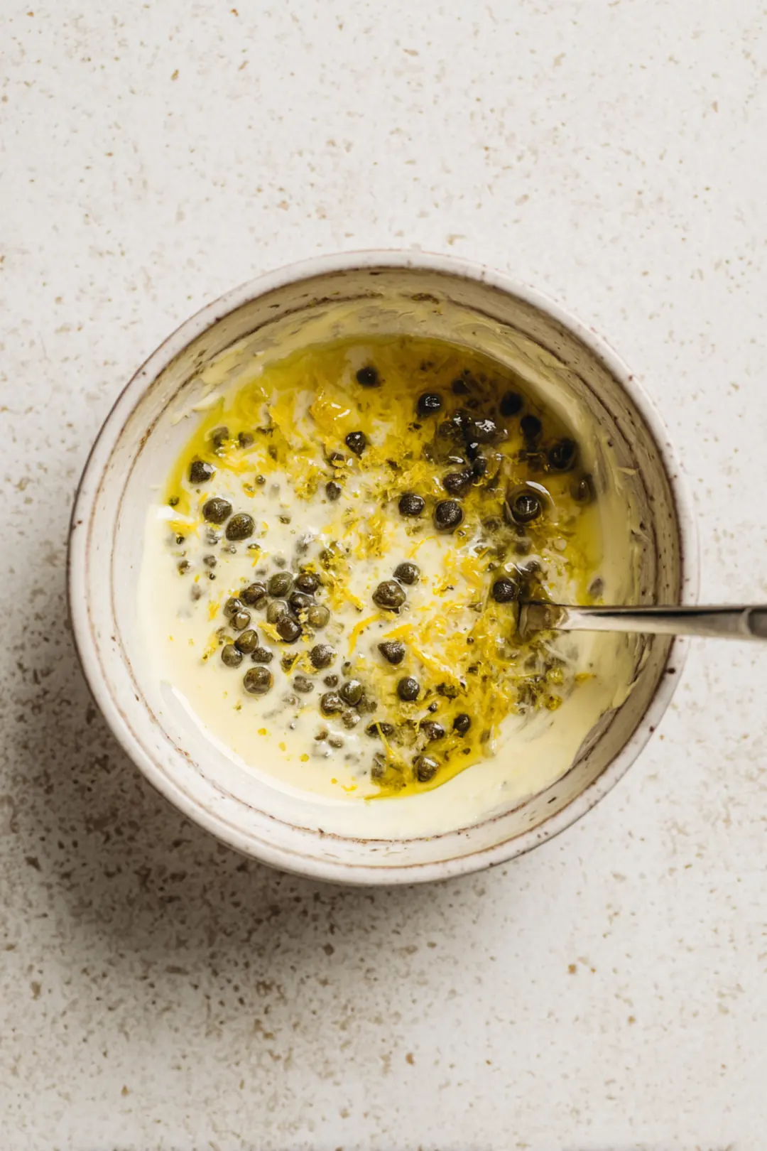Mix mayonnaise, capers, and lemon zest to create a zesty gourmet sauce