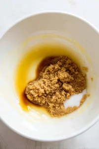 Mix melted butter, brown sugar, and white sugar until smooth