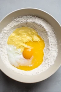 Mix milk, egg, and melted butter with dry ingredients until just combined