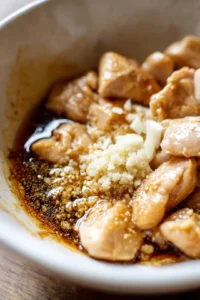 Mix together soy sauce, sake, mirin, grated ginger, and minced garlic in a bowl and add chicken pieces to marinate for 30 minutes