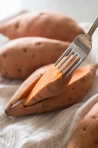 Pierce sweet potatoes with a fork to allow steam to escape during cooking