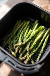 Place asparagus in air fryer basket and cook for eight minutes