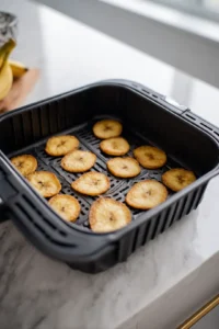 Place banana coins in a single layer in the air fryer basket