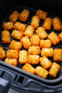 Place frozen tater tots in air fryer and cook for 10 minutes