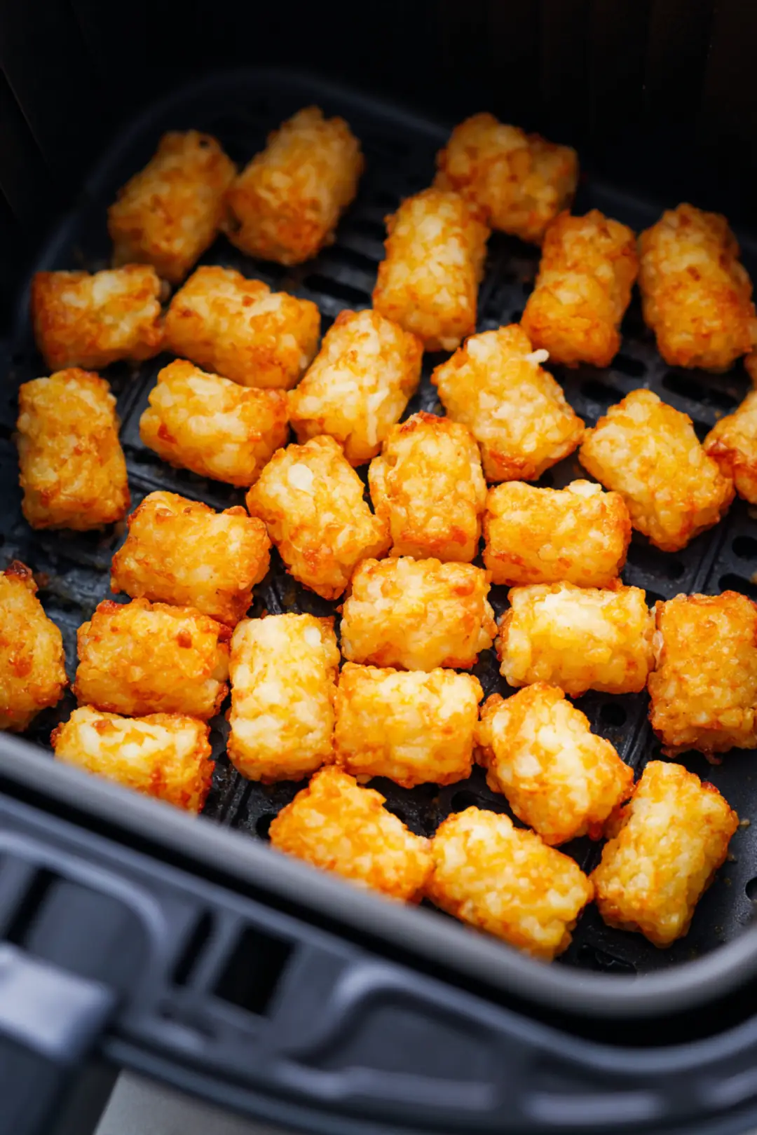 Place frozen tater tots in air fryer and cook for 10 minutes