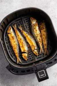 Place marinated mackerel in air fryer and cook until crispy