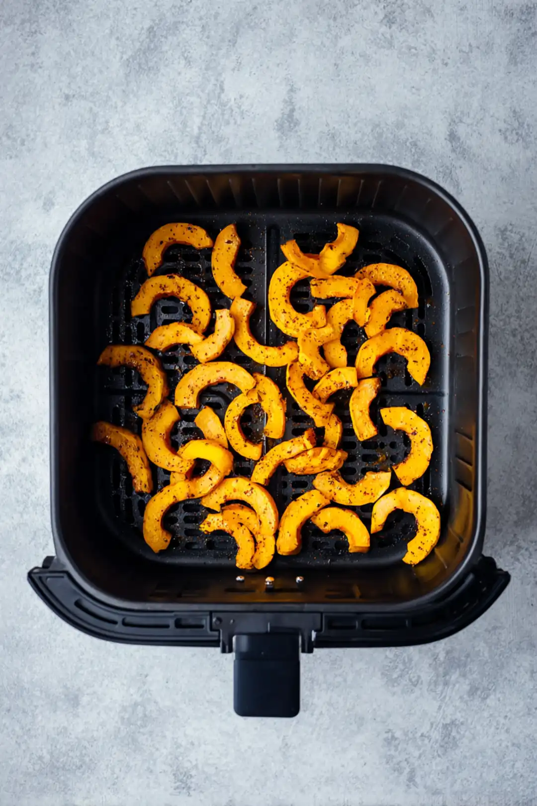 Place seasoned squash fries in air fryer