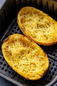 Place spaghetti squash halves in air fryer cut side down
