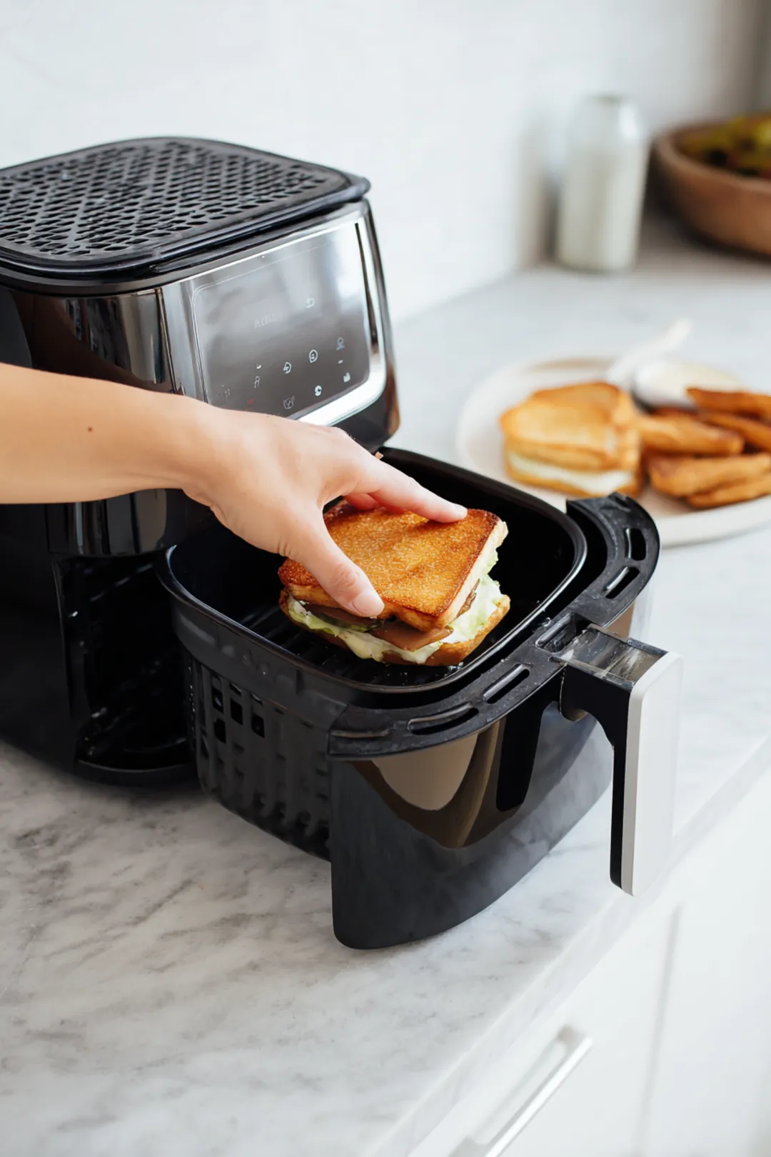 Place the assembled sandwich in the air fryer basket and cook for 8 minutes flipping halfway through until golden brown and crispy